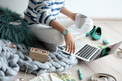 Photo of Female blogger with laptop and cup of coffee indoors