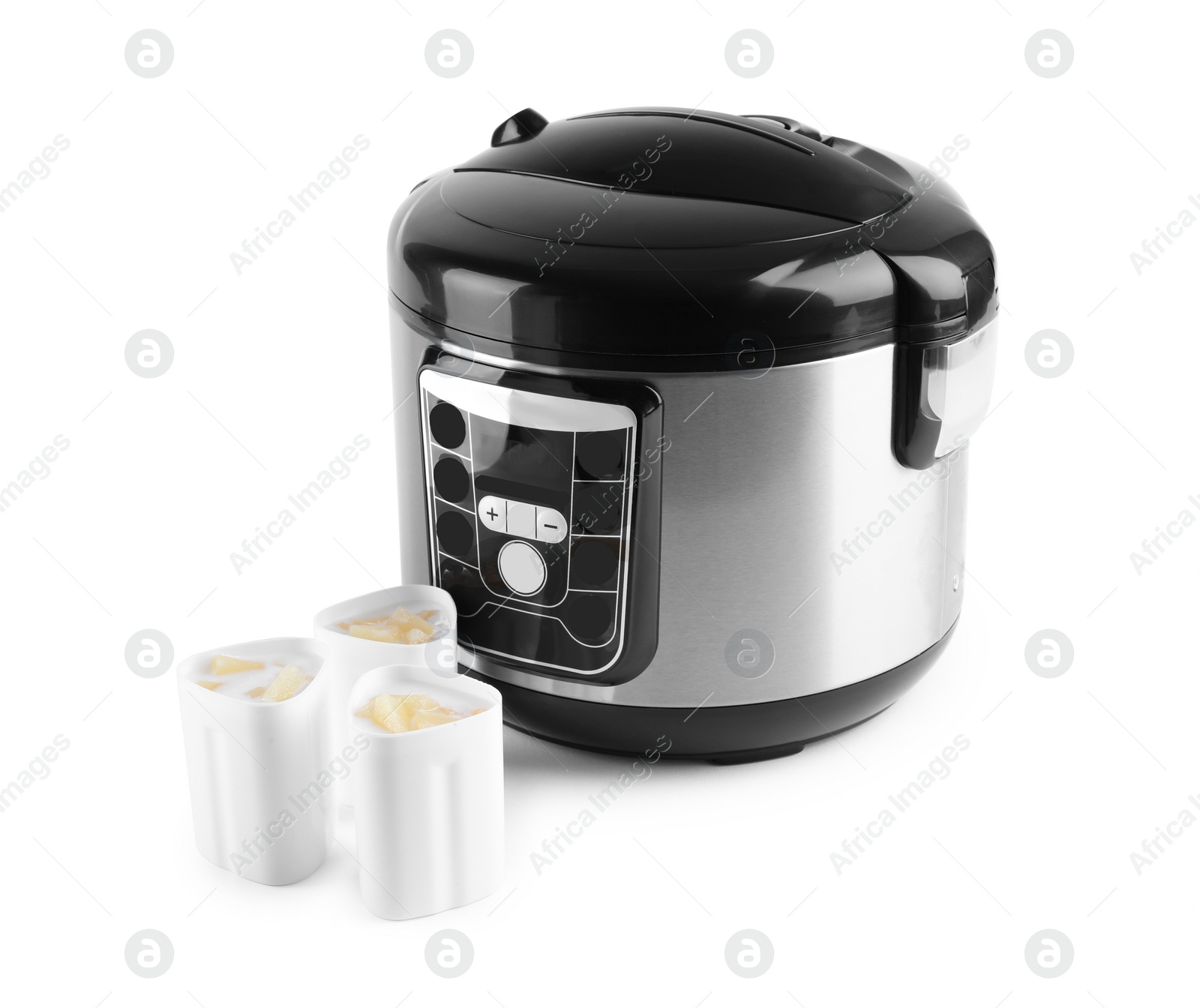 Photo of Multi cooker with cups of pineapple yogurt isolated on white