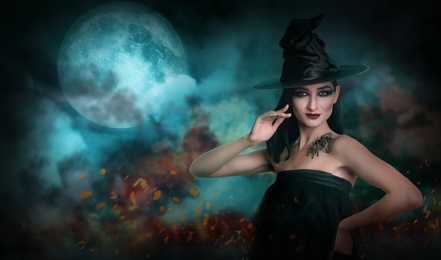 Image of Young girl dressed as witch with creepy spider on full moon night. Halloween fantasy