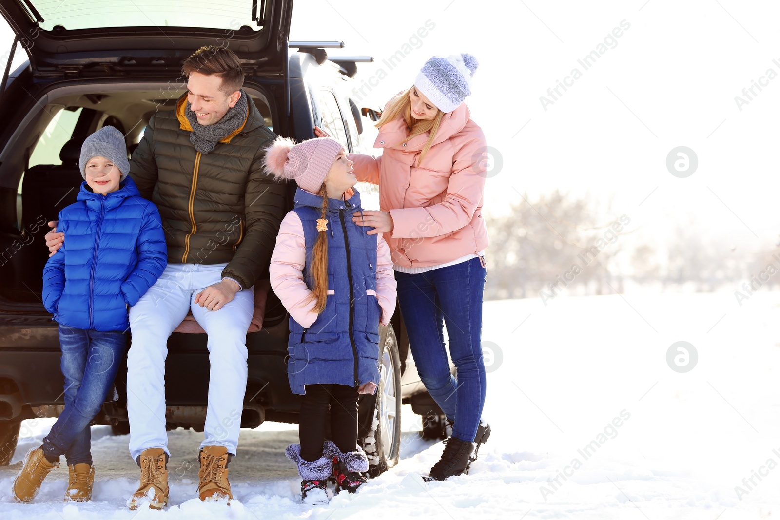 Photo of Happy family near car on winter day