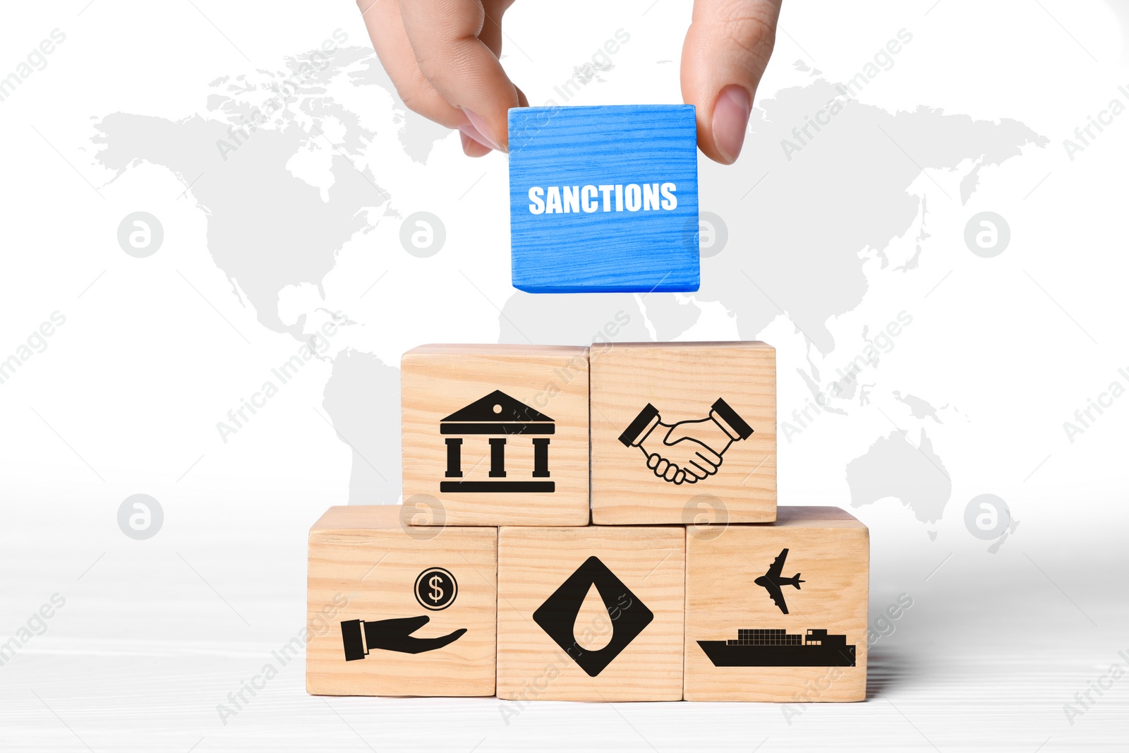 Image of Economic sanctions. Woman building pyramid of wooden cubes, closeup. Illustration of world map on white background