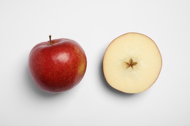 Photo of Ripe juicy red apples on white background, top view