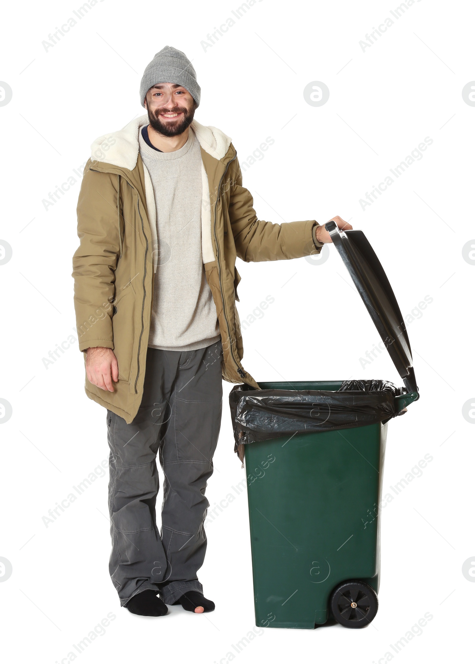 Photo of Poor homeless man near trash bin isolated on white