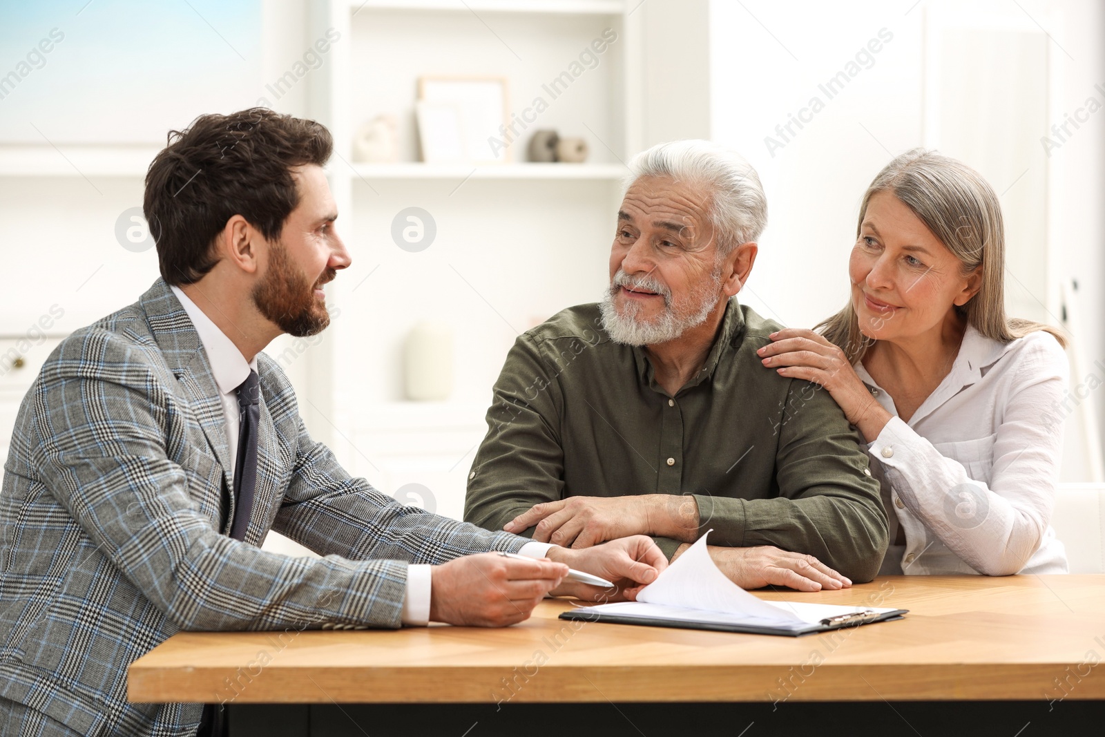 Photo of Notary consulting senior couple about Last Will and Testament in office