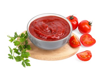 Organic ketchup in bowl, fresh tomatoes and parsley isolated on white. Tomato sauce