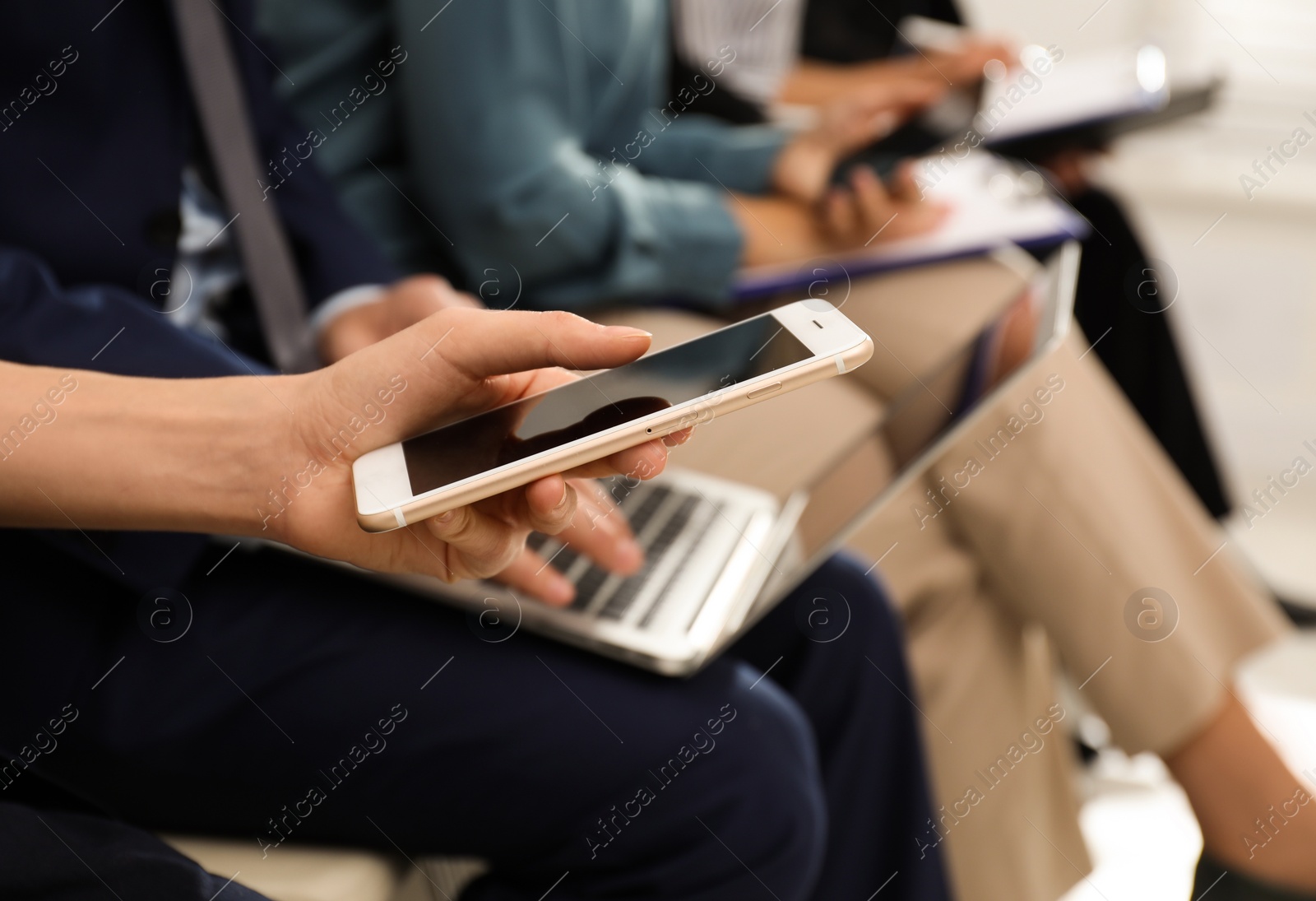 Photo of Woman with smartphone waiting for job interview in office, closeup