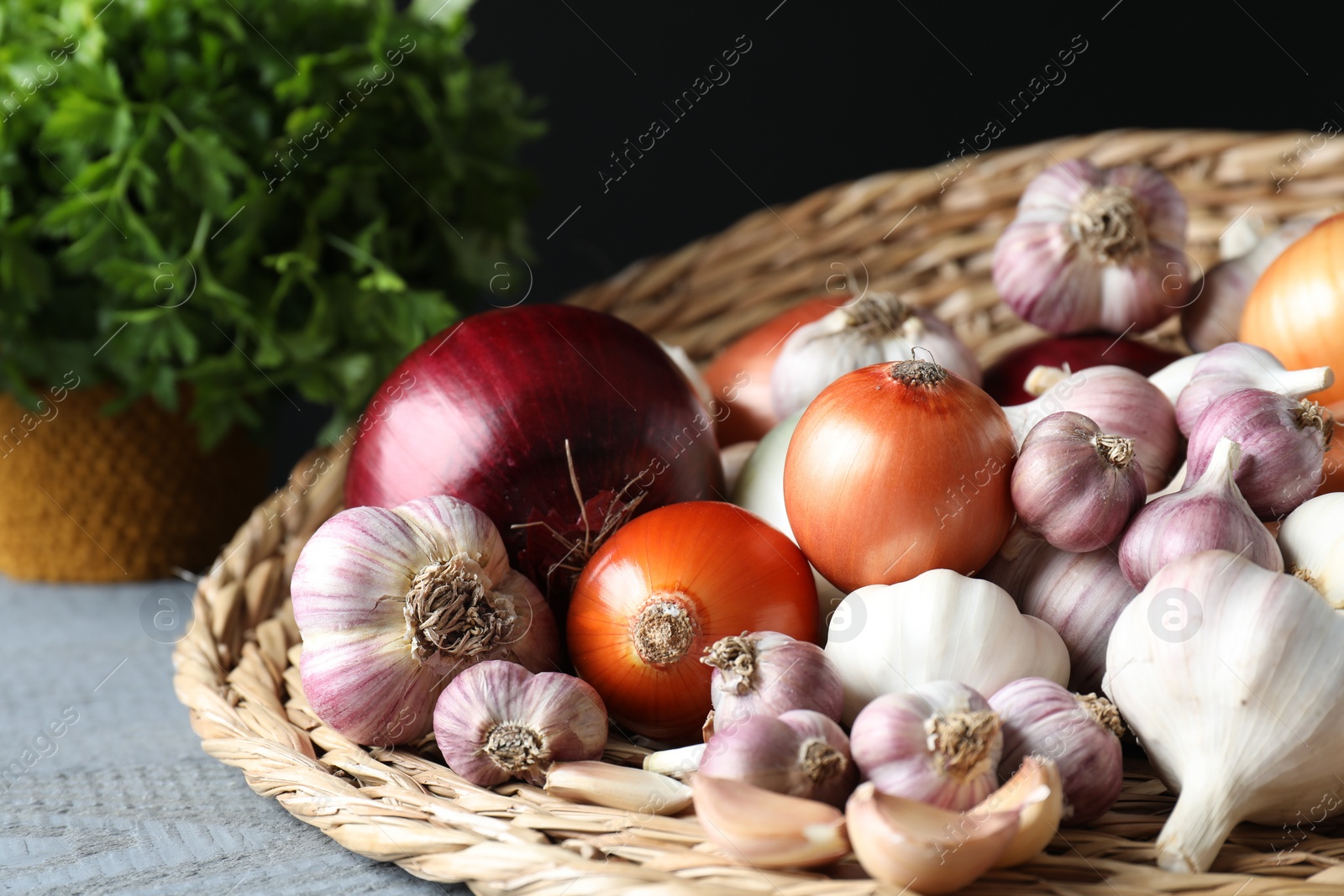 Photo of Fresh raw garlic and onions on table, closeup