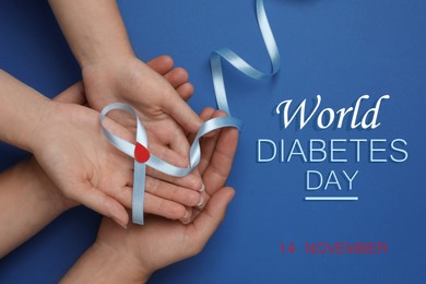 World Diabetes Day. People holding light blue ribbon with paper blood drop on color background, top view 