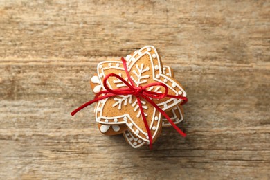 Tasty Christmas cookies with icing on wooden table, top view