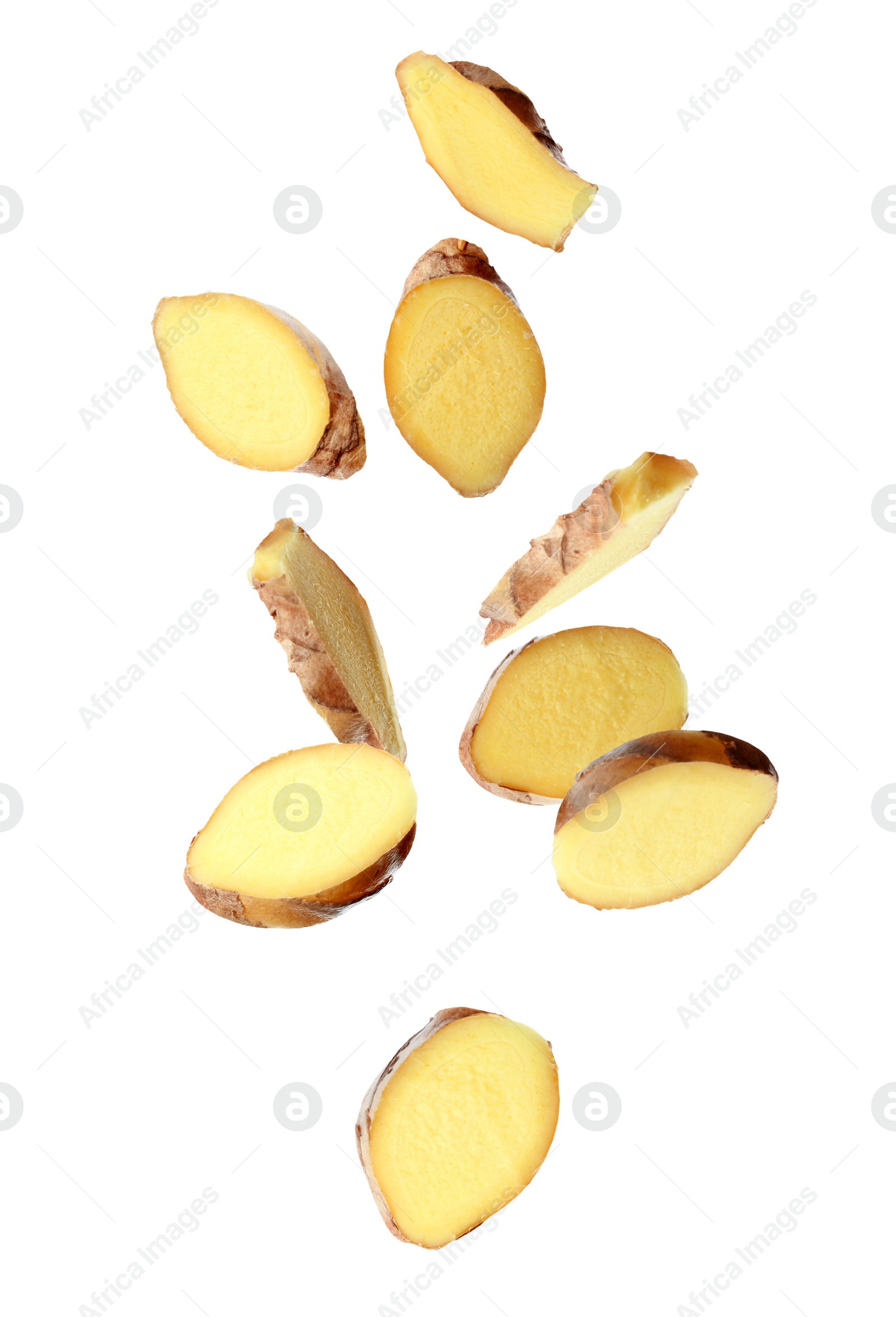 Image of Fresh sliced ginger falling on white background