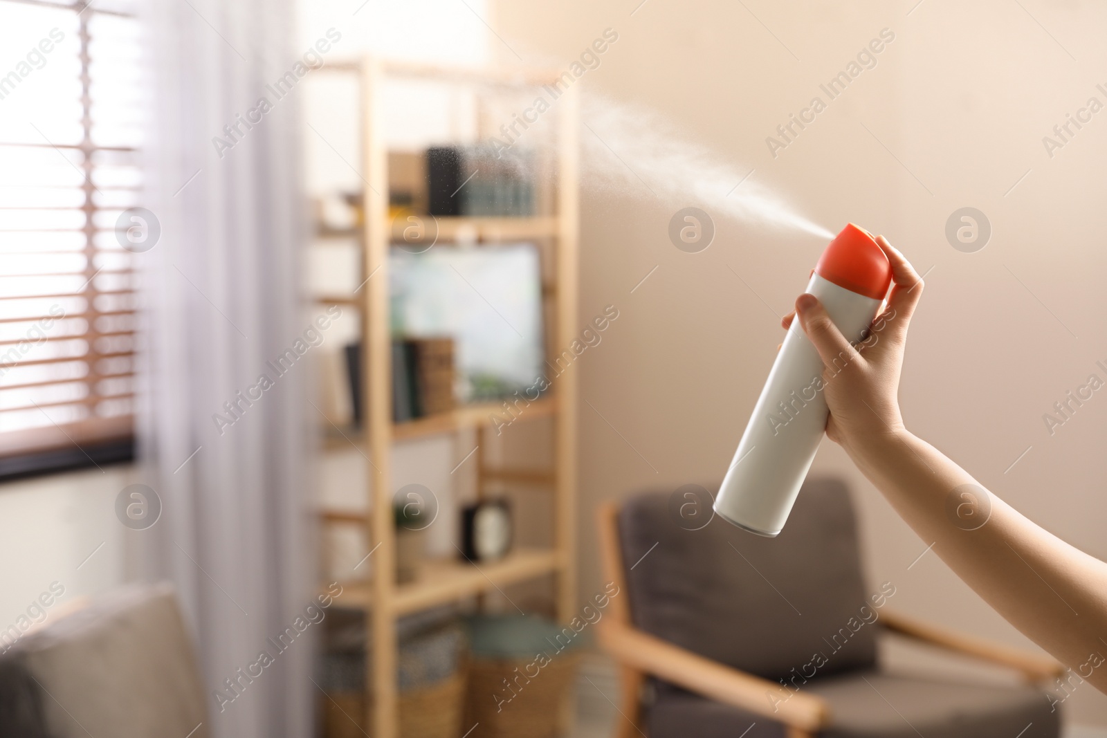 Photo of Woman spraying air freshener at home, closeup