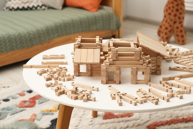 Wooden construction set on white table indoors. Children's toy