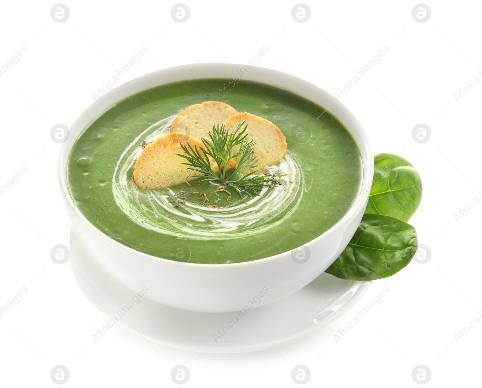 Photo of Fresh vegetable detox soup made of spinach with croutons in dish and leaves on white background