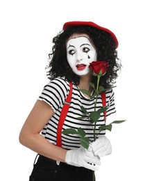 Photo of Funny mime with red rose posing on white background