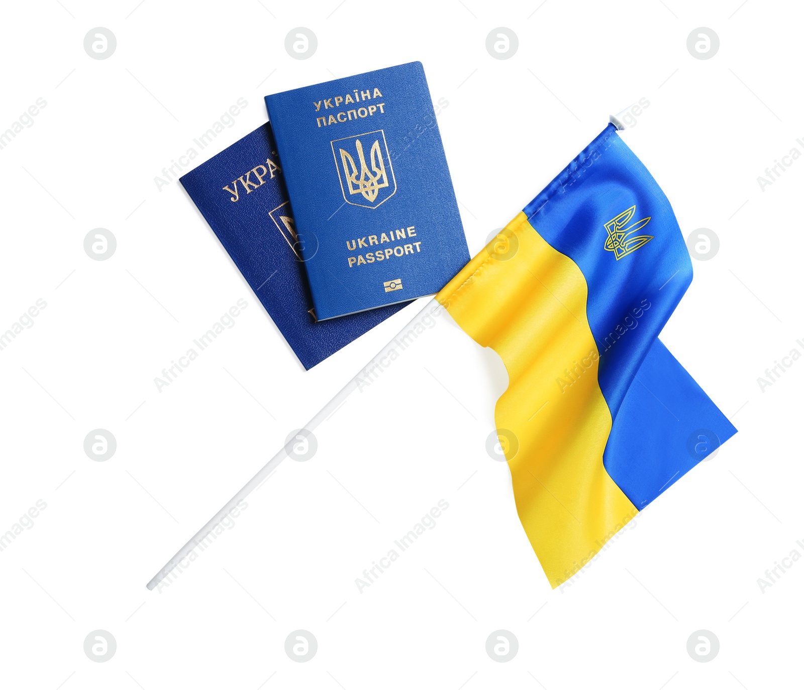 Photo of Ukrainian passports and national flag on white background, top view. International relationships