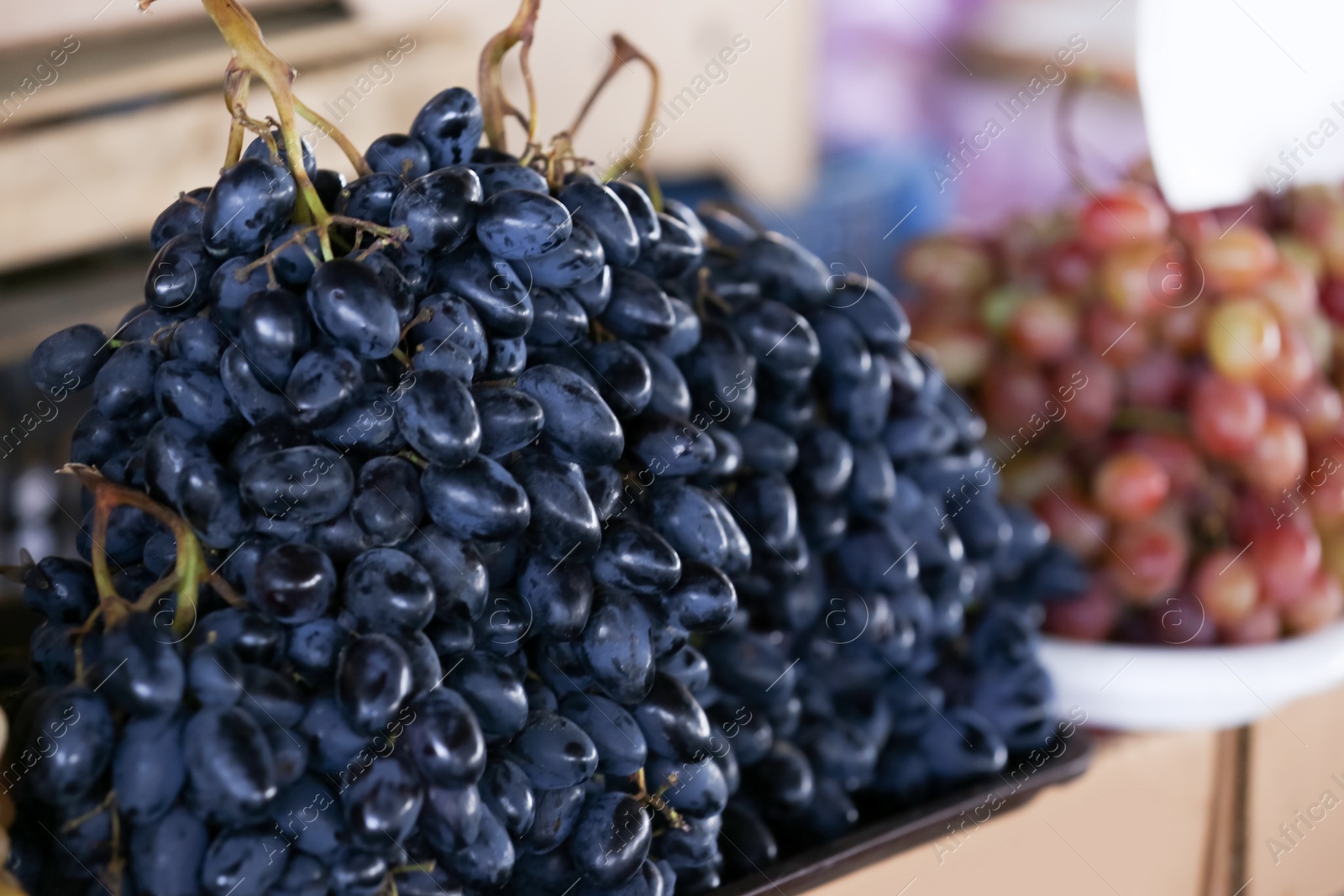 Photo of Fresh ripe juicy grapes on tray, closeup