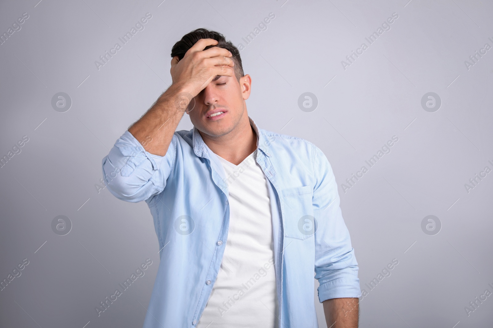 Photo of Portrait of stressed man on light background