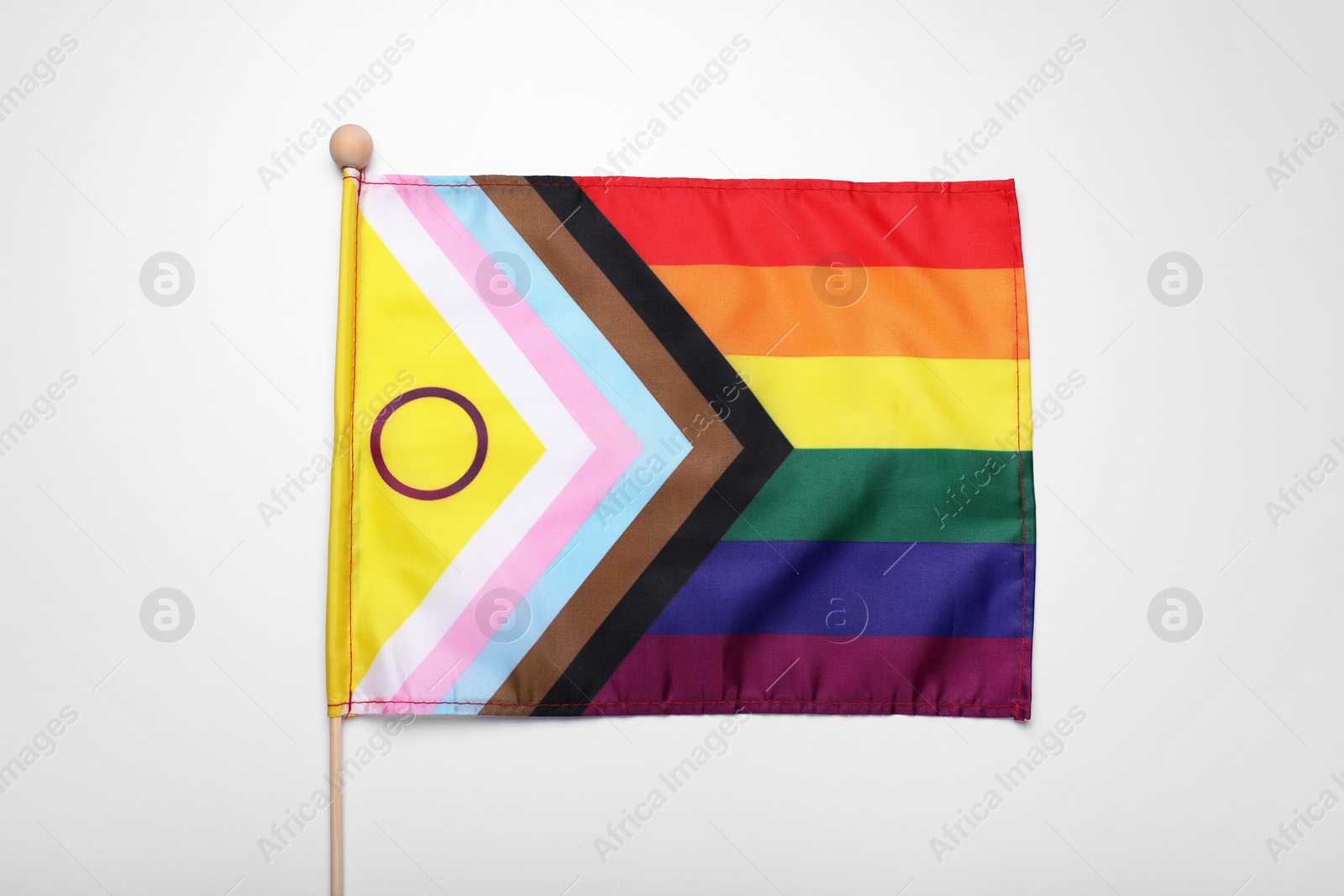 Photo of Bright progress flag on white background. LGBT pride