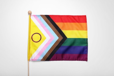 Photo of Bright progress flag on white background. LGBT pride
