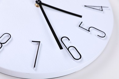 Photo of Stylish analog clock on white background, closeup