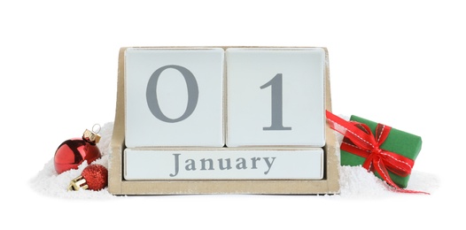 Photo of Wooden block calendar, gift and Christmas balls on white background. New Year celebration