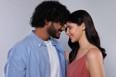 International dating. Portrait of happy couple on light grey background