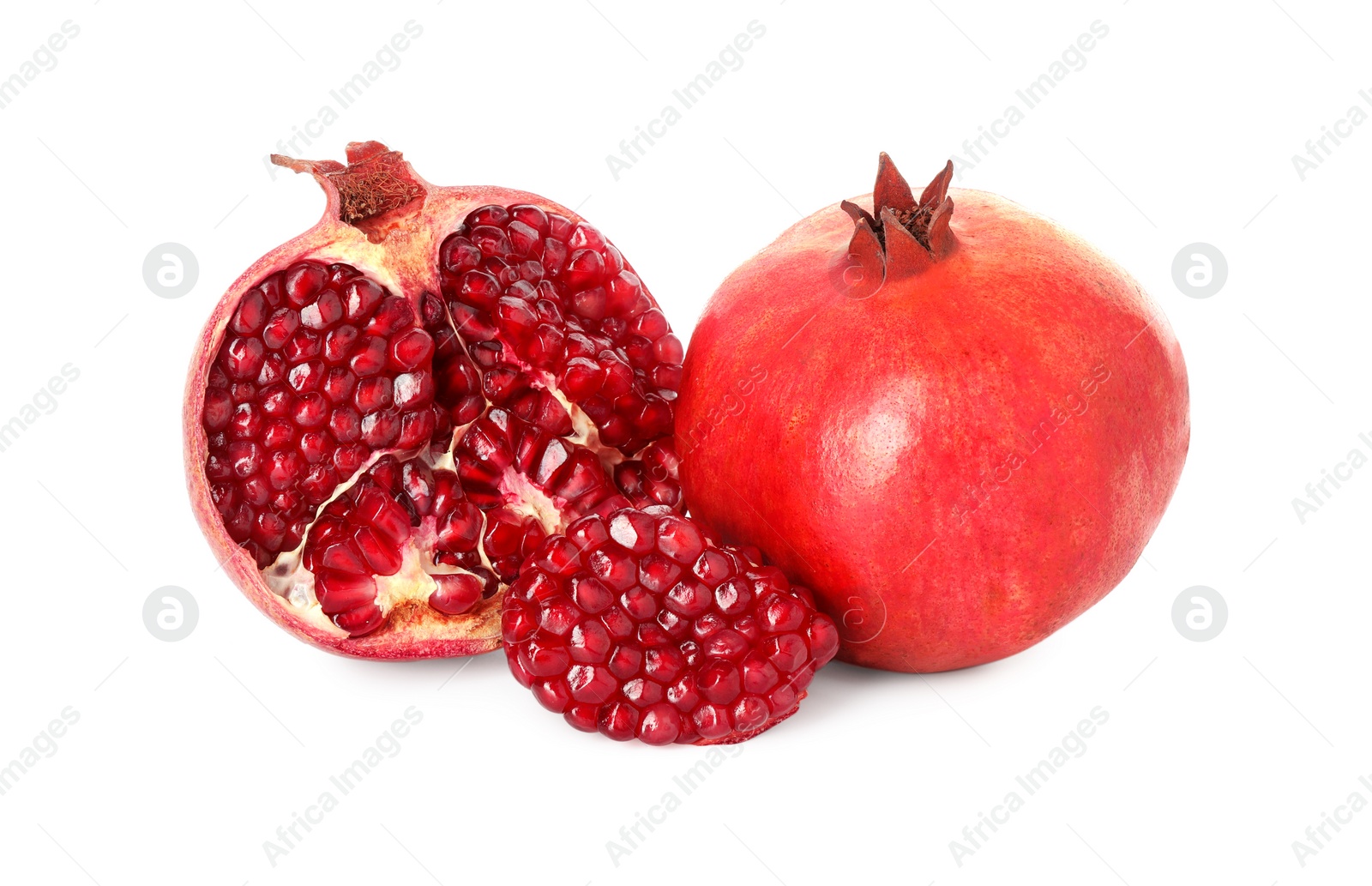 Photo of Half and whole pomegranates isolated on white