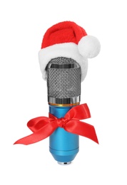 Photo of Microphone with Santa hat and red bow isolated on white. Christmas music