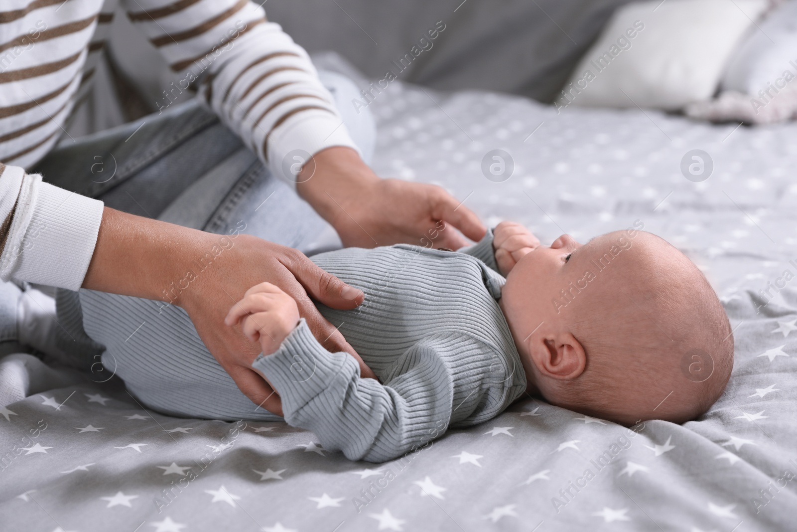 Photo of Mother and her little baby on bed, closeup