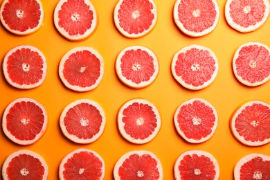 Photo of Fresh sliced ripe grapefruit on color background, flat lay