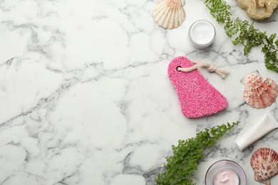 Photo of Flat lay composition with pumice stone on white marble background. Space for text