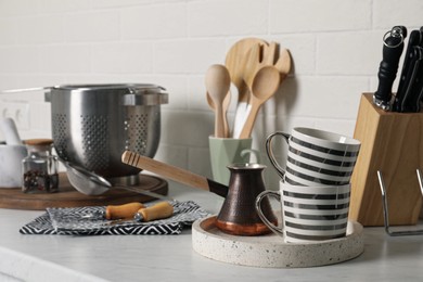 Photo of Different cooking utensils on countertop in kitchen