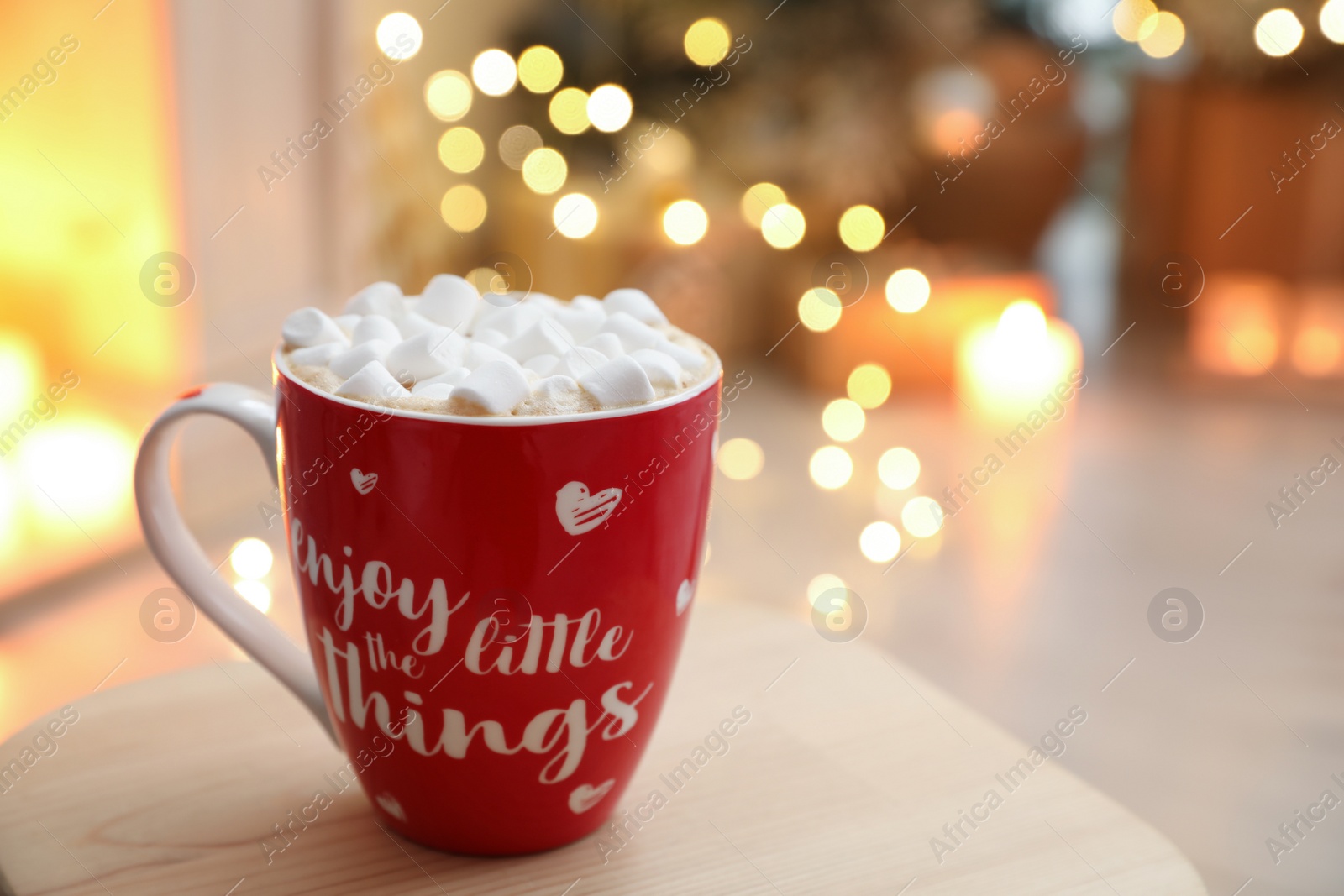 Photo of Hot drink with marshmallows in room. Magic Christmas atmosphere