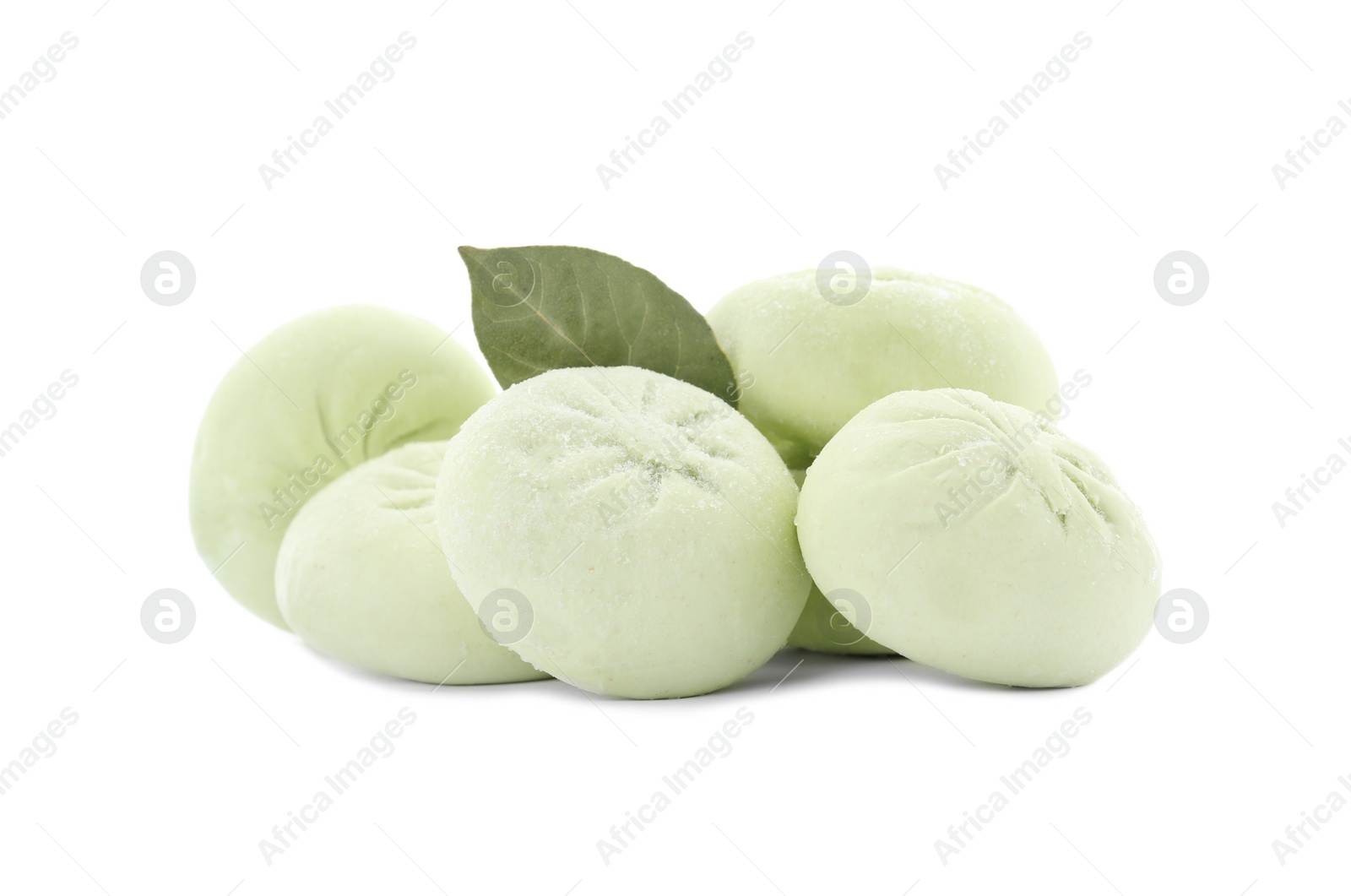 Photo of Raw dumplings with bay leaf on white background