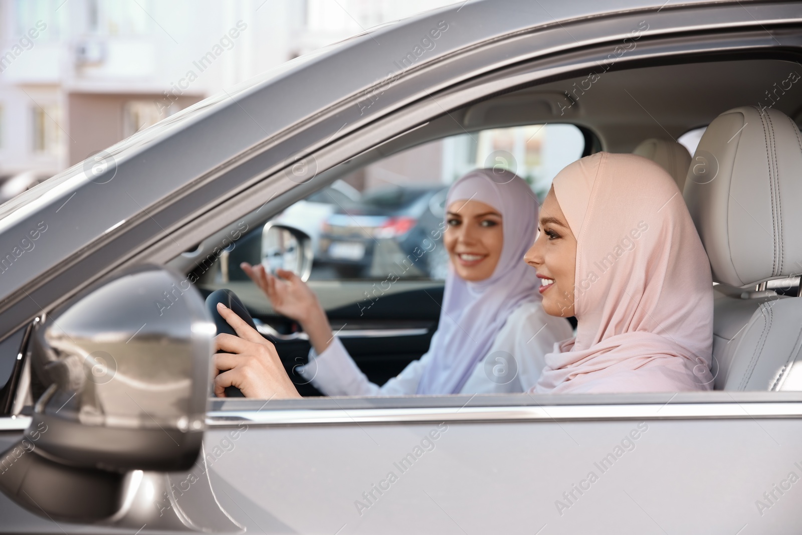 Photo of Female Muslim driver and her friend in car