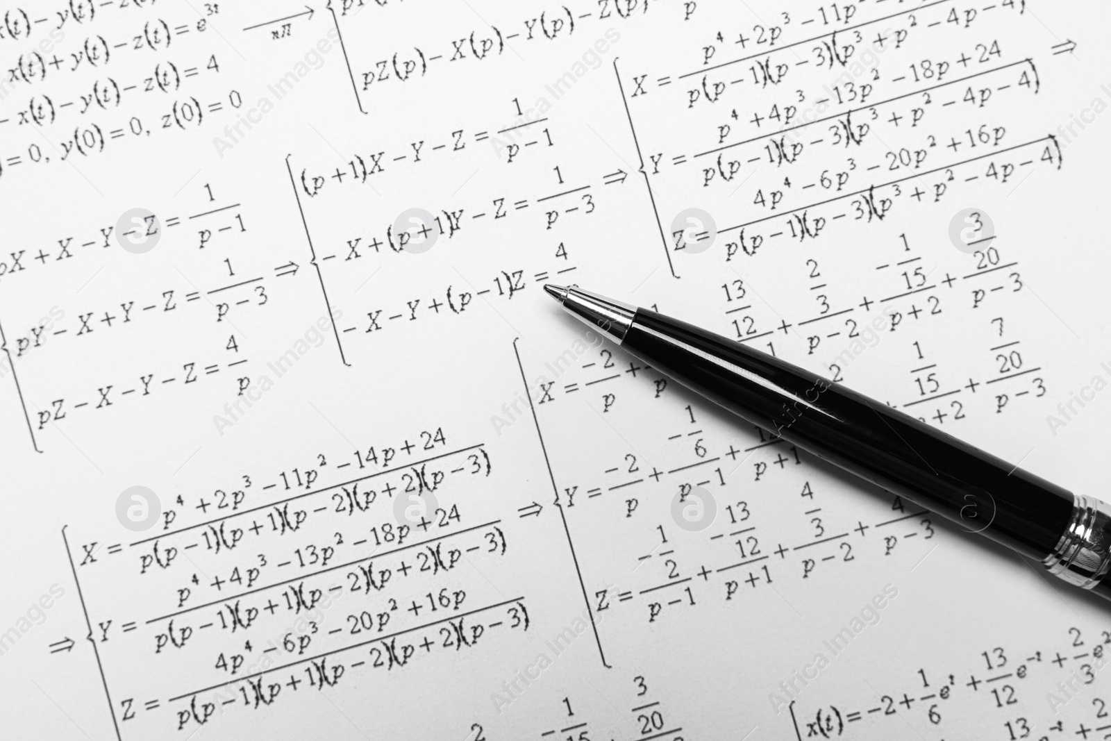 Photo of Sheet of paper with mathematical formulas and pen