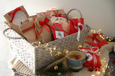 Photo of Set of gifts, coffee and Christmas decor on table. Advent calendar