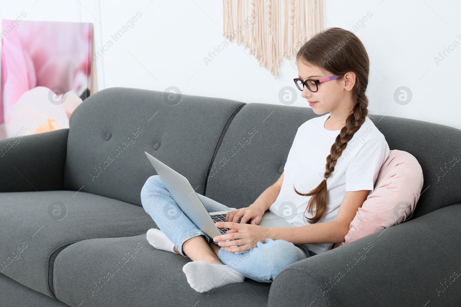 Photo of Girl with laptop on sofa at home