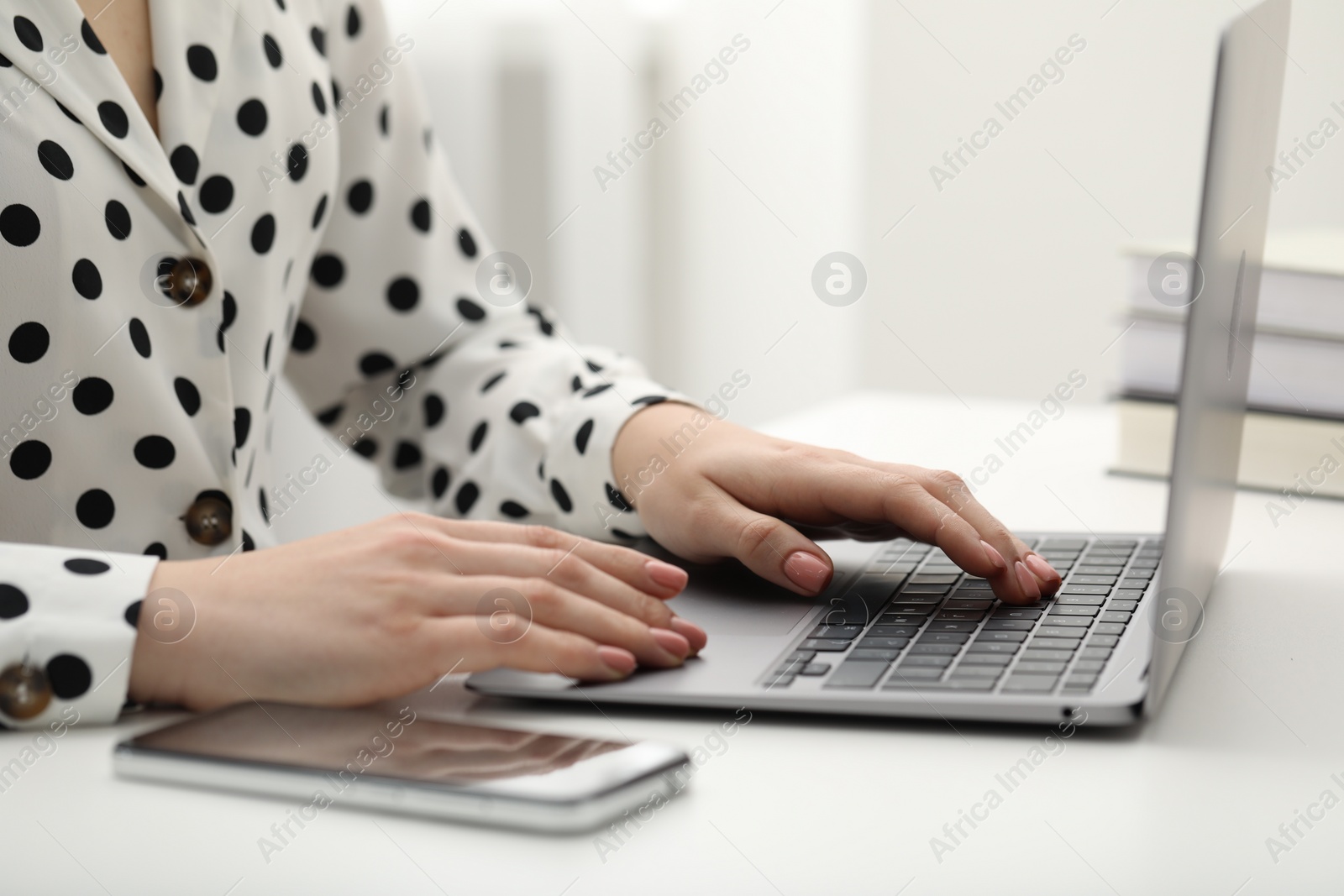Photo of E-learning. Woman using laptop during online lesson at table indoors, closeup