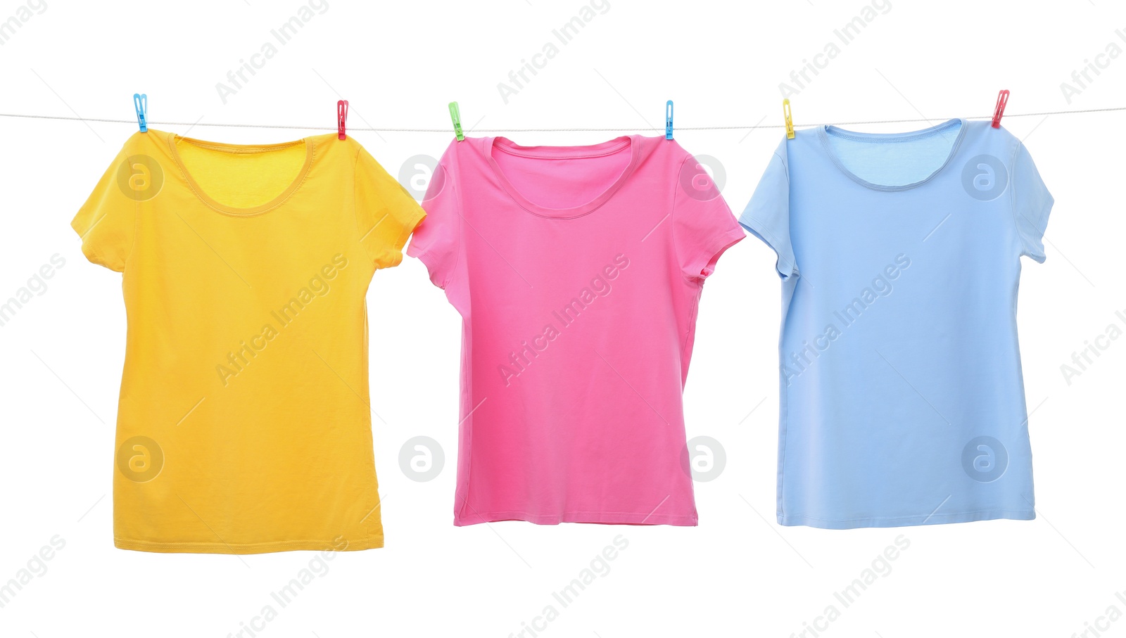 Photo of Colorful t-shirts drying on washing line isolated on white