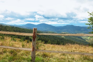 Photo of Wooden fence and picturesque view of mountain landscape