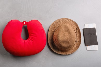 Flat lay composition with red travel pillow on light grey background