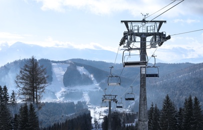 Photo of Beautiful mountain landscape with chairlift. Winter vacation