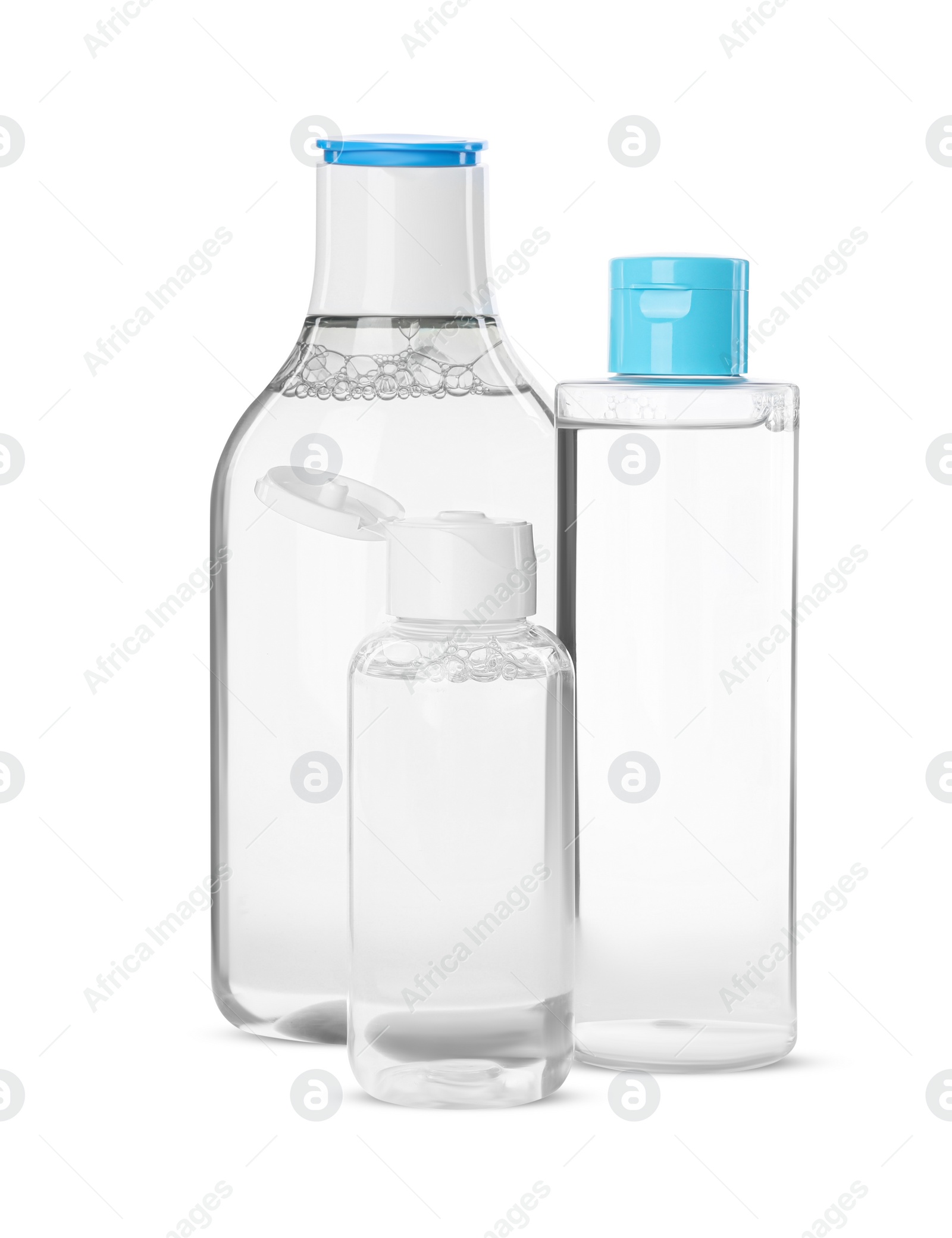 Photo of Bottles of micellar cleansing water on white background