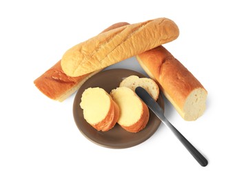 Photo of Cut baguettes with fresh butter on white background, above view