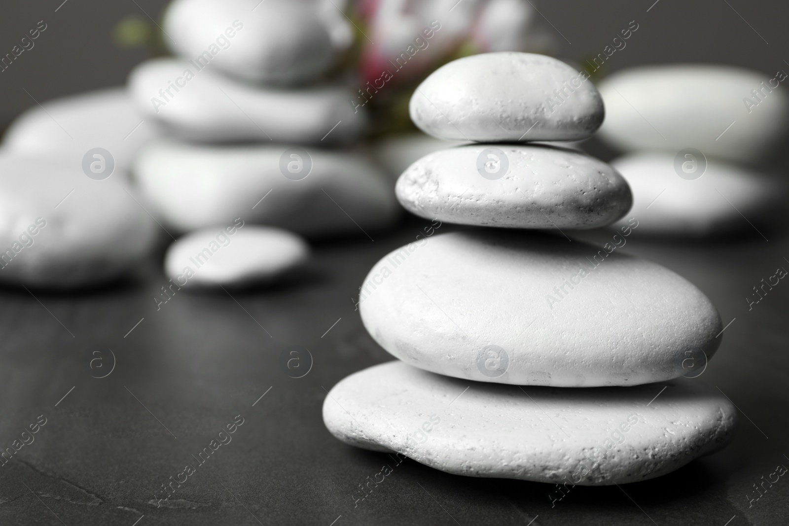 Photo of Stack of spa stones on table. Space for text