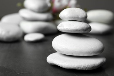 Stack of spa stones on table. Space for text