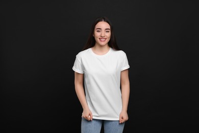 Photo of Woman wearing white t-shirt on black background