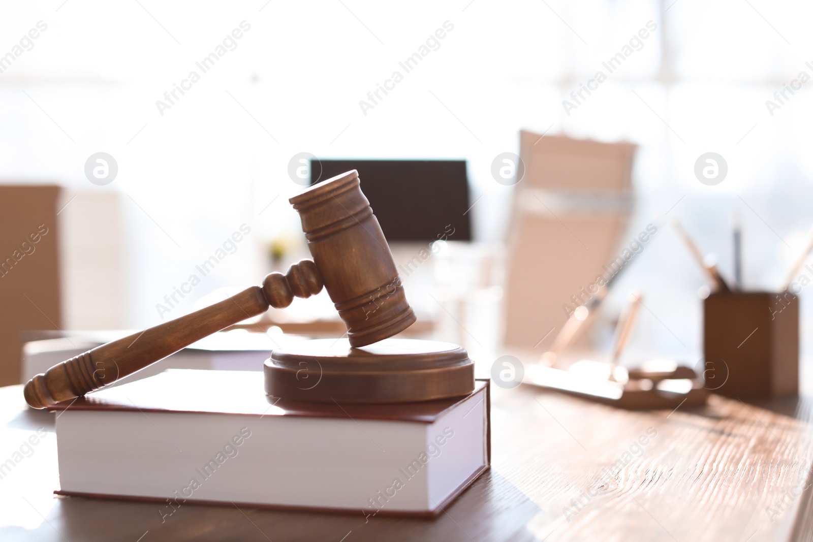 Photo of Gavel and book on table in lawyer's office