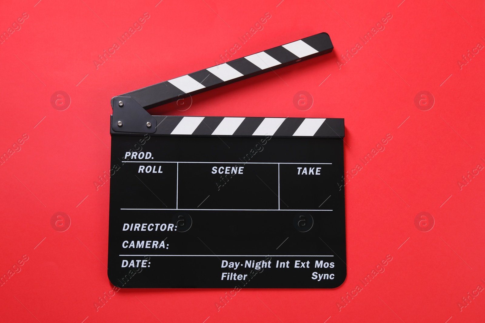 Photo of Clapperboard on red background, top view. Film industry